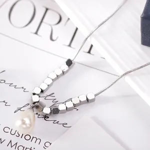 Minimalist titanium steel necklace with silver cubes and teardrop pearl on snake chain