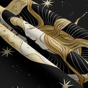 Detail showing high-density black fabric with gold moon and sun tarot-style embroidery