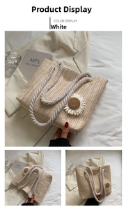 Detailed view of woven straw tote bag featuring a white daisy flower and rope handle