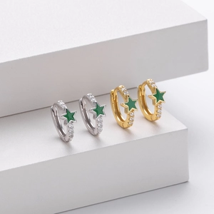 Detail of silver and gold hoops with green enamel stars and cubic zirconia accents