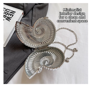 Macro view showing the metallic interior and snail shell structure of the silver evening bag