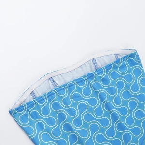 Detail of blue printed swimwear waist with white elastic band and precise stitching