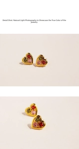 Detailed shot of golden heart earrings featuring three inlaid vibrant colored zircons