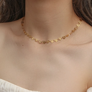Elegant gold hollow heart choker necklace set for women shown on a fashion model