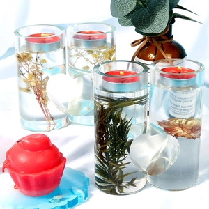 Detail of cylinder heart candle holders with dried flowers and red tealights