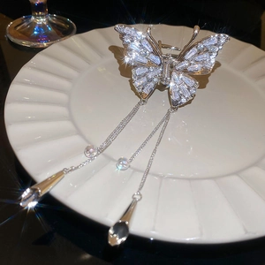 Elegant silver butterfly hair claw clip with sparkling rhinestones and long tassel chains