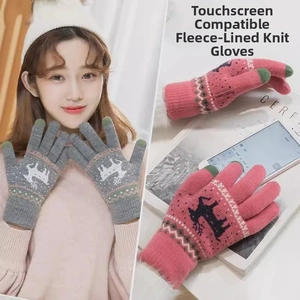 Close-up of winter knitted gloves featuring reindeer pattern and touchscreen fingertips