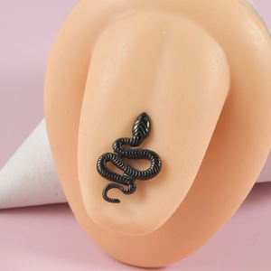 Detail of a black snake stud earring on a human ear model with a sleek metallic finish