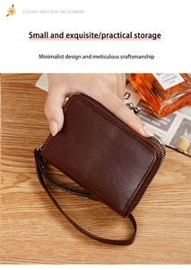 Detail of dark brown faux leather coin purse with wrist strap and zipper closure