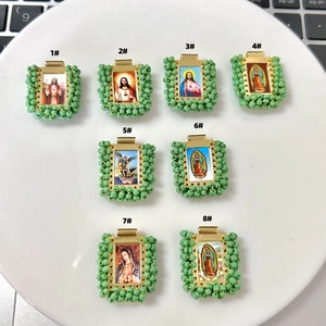 Detailed macro view of eight handmade religious saint charms woven with light green beads