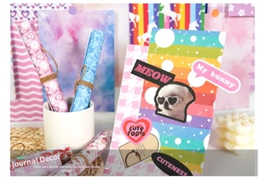 Detail of cute DIY scrapbook papers featuring pink hearts, rainbows, and cat patterns