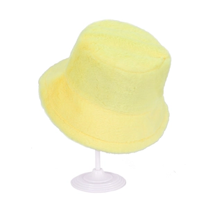 Bright yellow plush cashmere bucket hat for winter displayed on a white stand