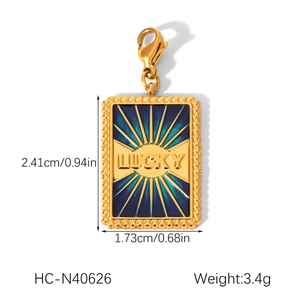 Golden rectangular LUCKY pendant with dimensions 2.41cm by 1.73cm and teal enamel design