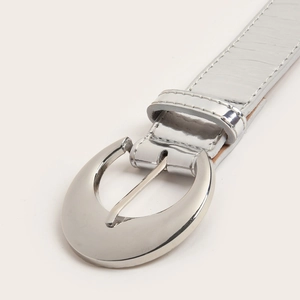 Classic silver skinny belt for women with large oval metal buckle and textured strap