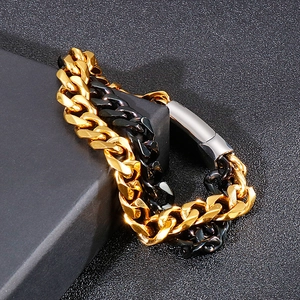 Detail of gold and black dual-layer Cuban chain bracelet with polished buckle