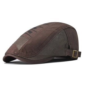 Detail of dark brown flat cap showing breathable mesh panels and metal adjustment buckle