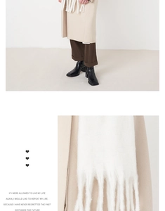 Detail shot of white cashmere-like scarf fringe and elegant winter outfit texture