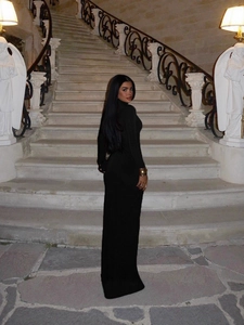 Elegant high neck backless black maxi dress with long sleeves and slim fit silhouette