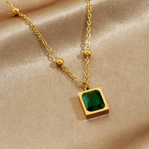 Gold plated stainless steel necklace with green square pendant on champagne satin