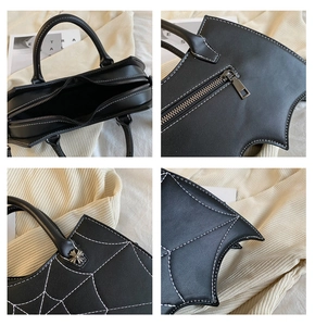 Macro details of bat wing design bag with spider web embroidery and silver hardware