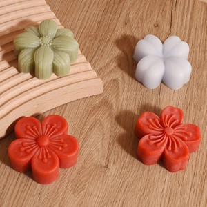 Detail view of 3D floral silicone molds for aromatherapy candles and soaps on wood