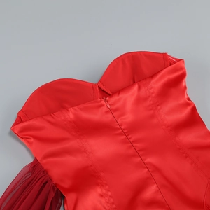 Detail of burgundy mesh splicing and satin fabric with zipper closure on red evening dress