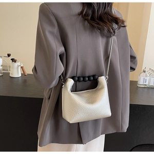 Silver textured leather mini dumpling bag with black beaded handle and metal chain strap