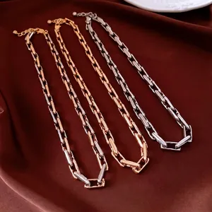 Adjustable metal paperclip chain necklaces in gold and silver finishes on silk fabric