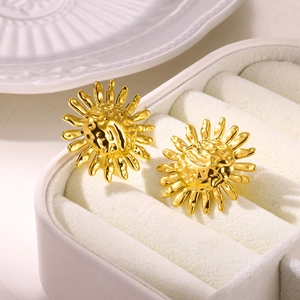 Textured gold sunflower earrings in vintage stainless steel on jewelry display box