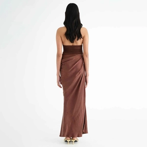 Detail view of the brown satin dress showing open back design and draped fabric texture