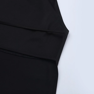 Detail of premium black fabric stitching and refined seam finish on slim-fit set