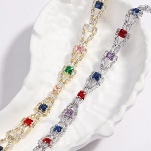 Detail of colorful 4mm zircon tennis bracelets in gold and silver plating on white tray