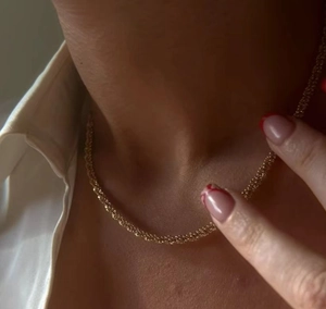 Sparkling 18k gold plated choker chain for women on white shirt, elegant vintage style