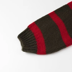 Detail of ribbed cuffs on rainbow striped knit sweater in olive green and red