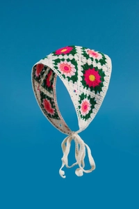Close-up of handmade crochet floral bandana with intricate knit texture and tie straps