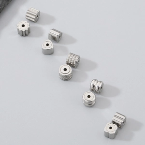 Macro shot of 304 stainless steel heart and geometric beads for DIY jewelry making