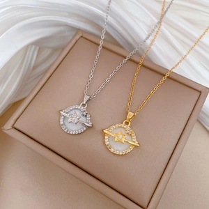 Detailed close-up of gold and silver shell planet necklaces with sparkling zircon details