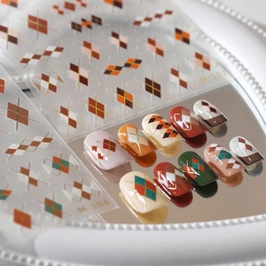 Classic Argyle nail stickers with gold lines and matte texture in warm coffee and red-green