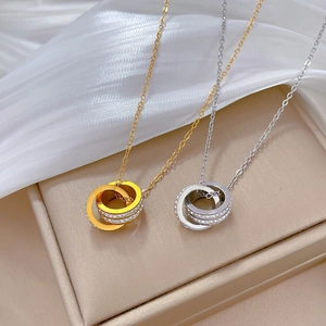 Minimalist double interlocking ring necklace set in gold and silver with zircon accents