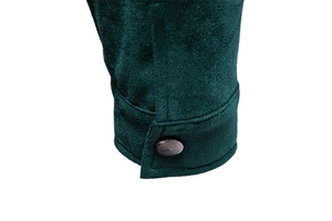 Detail of dark green suede jacket cuff featuring a black metal button with Classic text