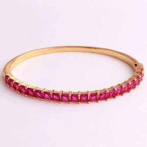 Detailed close-up of luxurious 18K gold plated bracelet with square red zircon stones