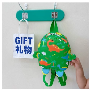 Detail of green kids dinosaur backpack with cartoon prints and side fin decorations