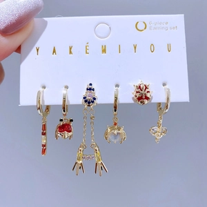 Detailed view of 6-piece gold earring set with colorful zircon stones on display card