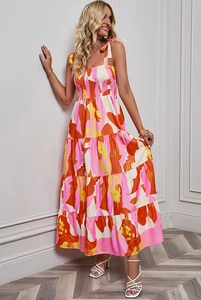 Detail of the pink and orange floral print dress with smocked waist and tie-up straps