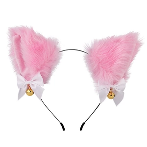 Close-up of pink plush cat ears headband with white bows and small golden bells detail