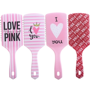 Detail view of large air cushion massage hairbrushes with pink and white floral patterns