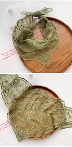 Detail of pea green lace triangle scarf featuring intricate floral embroidery on mesh fabric