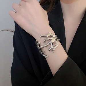 Close-up of liquid metal branch cuff bracelet in silver finish on a model's wrist
