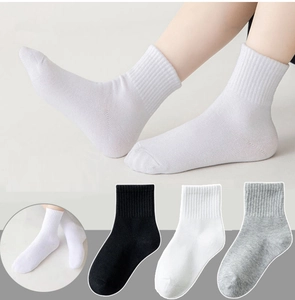 Detail of breathable cotton crew socks in white, black, and grey for kids and teens