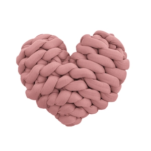 Detail of a handmade pink knotted heart-shaped cushion in soft chunky woven yarn style